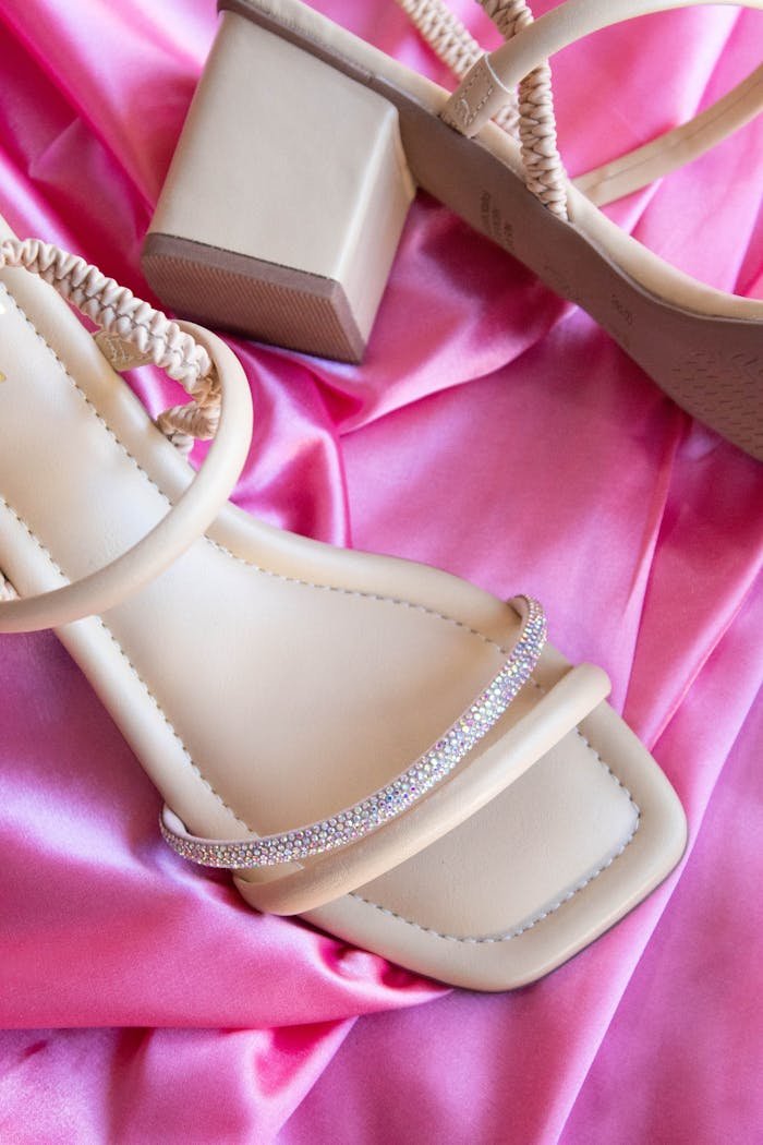 elegant-beige-heeled-sandals-on-pink-fabric-32851160