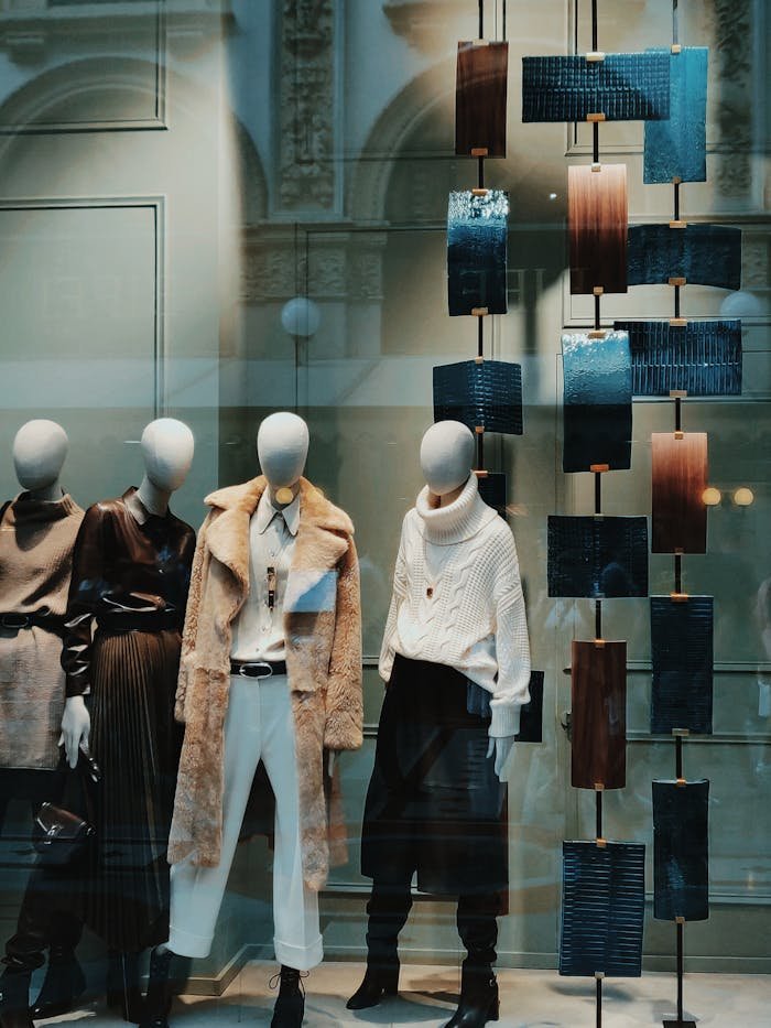 Stylish window display with modern fashion on mannequins. Perfect for showcasing boutique elegance.